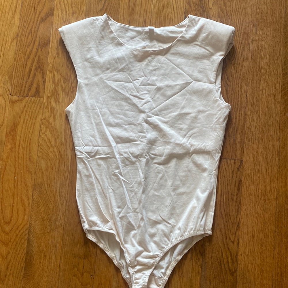 Cream short sleeve body suit with padded shoulders